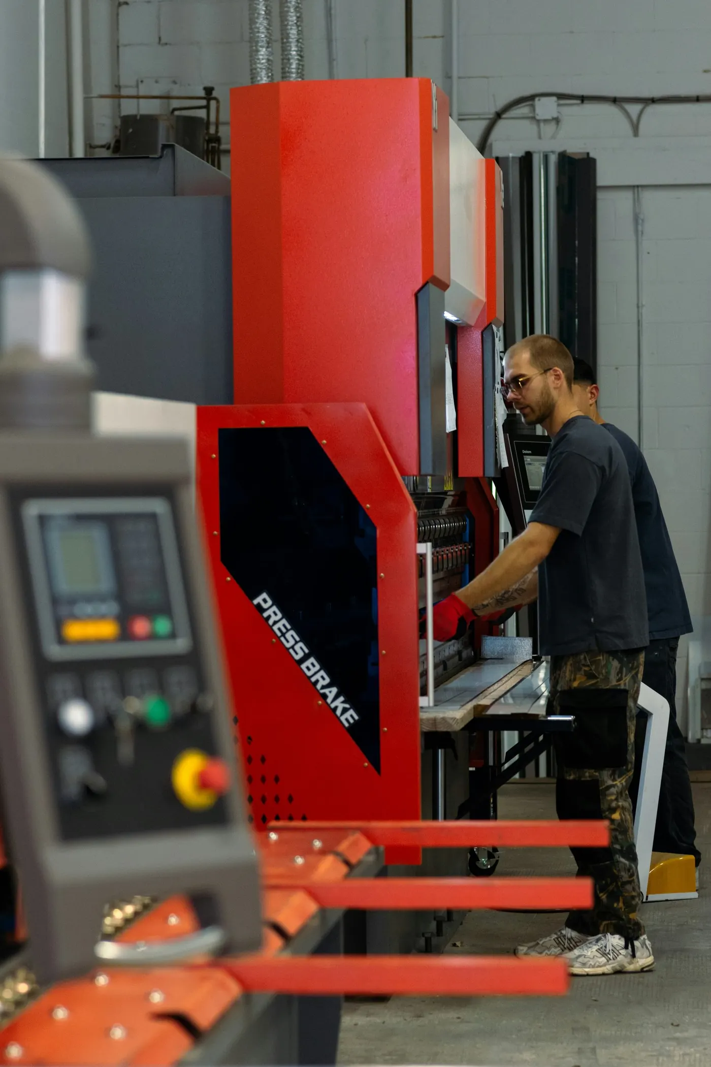 Worker operating industrial manufacturing equipment